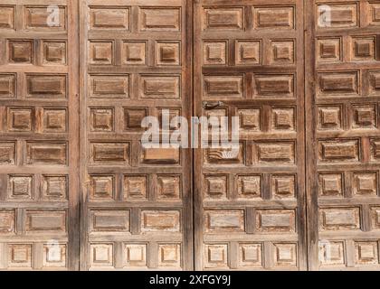 Vecchia porta in legno con una piccola serratura e una maniglia in ferro. Texture, sfondo Foto Stock