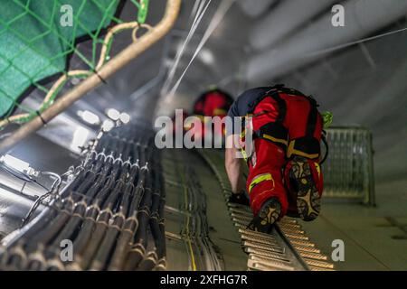 I soccorritori in altezza dei vigili del fuoco professionisti di Oberhausen praticano la discesa da una turbina eolica da un'altezza di 150 metri, salendo fino alla t Foto Stock