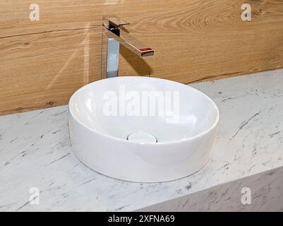 Lavandino ovale in ceramica bianca all'interno del bagno moderno Foto Stock