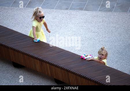 Due ragazze in panchina, una caduta mentre giocava. Foto Stock