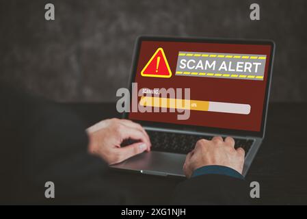 Schermo del notebook con avviso di truffa. Mette in evidenza la cybersicurezza, le frodi online, la consapevolezza dei rischi digitali. Adatto per sicurezza tecnologica e cassaforte Internet Foto Stock