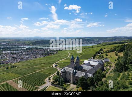 9 luglio 2024, Assia, Rüdesheim am Rhein: Solo alcune nuvole bianche si spostano attraverso il cielo altrimenti blu sopra l'abbazia di S. Hildegard nel Rheingau (vista aerea con un drone). Il tempo dovrebbe continuare a mostrare il suo lato estivo nei prossimi giorni. Foto: Boris Roessler/dpa Foto Stock