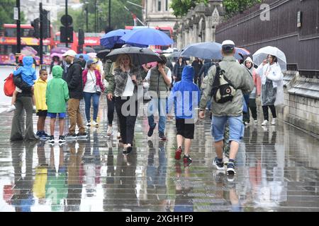 Londra, Regno Unito. 9 luglio 2024. Westminster Londra 9 luglio 2024. I visitatori di Westminster combattono sotto la pioggia mentre Londra e il sud-est dell'Inghilterra ricevono un'altra giornata di cattive condizioni meteorologiche estive Credit: MARTIN DALTON/Alamy Live News Foto Stock