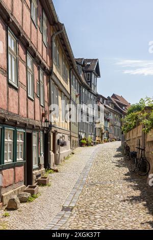 Vicolo alla base dello Schlossberg (collina del castello) nella città vecchia di Quedlinburg, Sacony-Anhalt, Germania. Vecchie case tradizionali in legno. Foto Stock