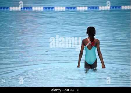 New York, Stati Uniti. 9 luglio 2024. Un giovane bagnante attende nella parte bassa della piscina Astoria mentre apre, una delle piscine pubbliche di New York City nel quartiere di Queens, New York, il 9 luglio 2024. Aperta a pieno regime per la prima volta quest'estate e pronta a ospitare più di 2000 persone, la piscina misura 330 x 165 metri ed è la più grande delle undici piscine dell'era WPA. (Foto di Anthony Behar/Sipa USA) credito: SIPA USA/Alamy Live News Foto Stock