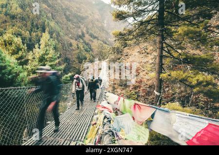 Gli escursionisti da vicino attraversano il famoso ponte sospeso Hillary sulla strada per il campo base dell'Everest. Trekking EBC. Popolare e impegnativo trekking Hima Foto Stock