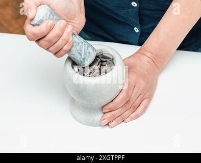 La donna sta argentando monete nello stupa della farmacia Foto Stock