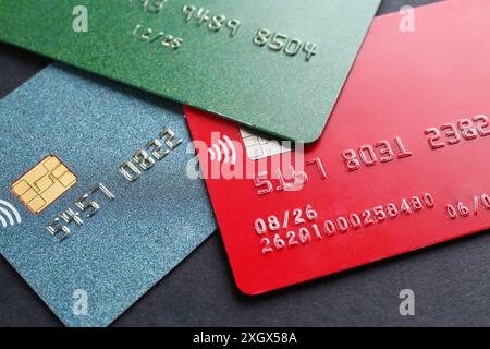 Carte di credito diverse su sfondo nero, primo piano Foto Stock