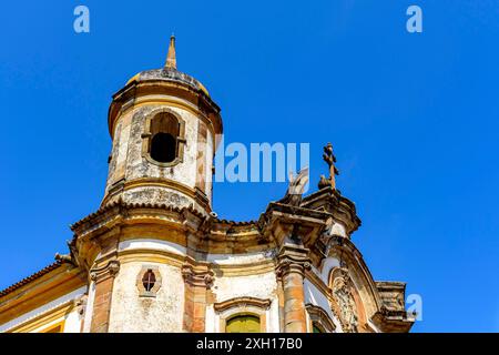 Storico campanile in stile barocco a Ouro Preto, stato Minas Gerais con cielo blu sullo sfondo Foto Stock