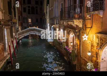 Venezia di notte in Italia. Pittoresco canale Rio dei Ferai con passerella pedonale e antichi edifici tradizionali nel quartiere di San Marco. Foto Stock