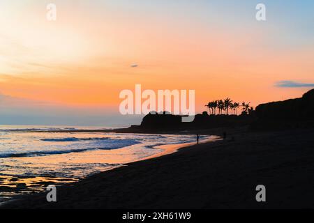 Sunset on the beach by the ocean, Indonesia. Stock Photo