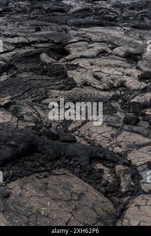 Close up view of dried, extrusive lava rock over a volcanic landscape. Stock Photo