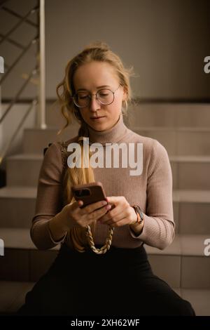 Young woman in glasses with phone Stock Photo