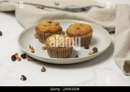 Three muffins served on a small plate Stock Photo