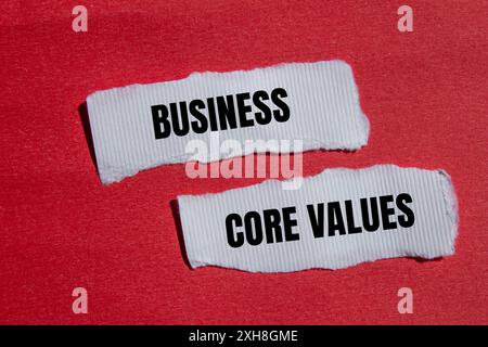 Messaggio Business Core Values scritto su un white paper strappato con sfondo rosso. Simbolo dei valori fondamentali aziendali concettuali. Copia spazio. Foto Stock