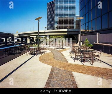 Patio con architettura aziendale e tavoli e sedie. Foto Stock