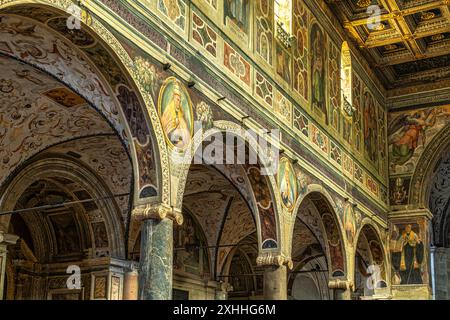 Dettagli degli archi riccamente decorati e delle colonne in stile barocco che dividono le navate dell'Abbazia di Farfa. Fara in Sabina, provincia di Rieti, IT Foto Stock