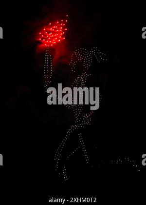 Parigi, Francia, 14 luglio 2024. Droni luminosi raffiguranti il portabicchieri olimpico nel cielo della Torre Eiffel - Jacques Julien/Alamy Live News Credit: Jacques Julien/Alamy Live News Foto Stock