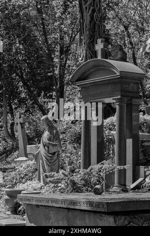 B&W immagina una volta di famiglia e altre tombe a Highgate Cemetery, Londra, Regno Unito Foto Stock