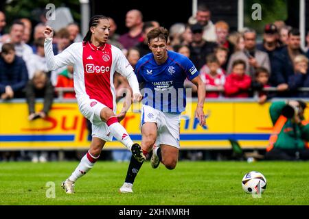 WEZEP, PAESI BASSI - 13 LUGLIO: Kian Fitz-Jim dell'AFC Ajax passa la palla sotto pressione di Kieran Dowell dei Rangers FC durante l'amichevole pre-stagione Foto Stock