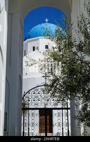 La chiesa delle tre Campane di Fira, Santorini, che guarda attraverso il cancello d'ingresso sottostante Foto Stock