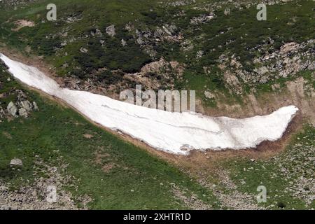 REGIONE DI ZAKARPATTIA, UCRAINA - 14 LUGLIO 2024 - la neve non si è ancora sciolta nonostante la temperatura di 35°C vicino al lago di montagna più alto dell'Ucraina, Brebeneskul, nella riserva della biosfera dei Carpazi, distretto di Rakhiv, regione di Zakarpattia, Ucraina occidentale Foto Stock