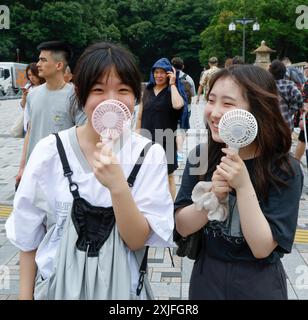 SCALDARE LE RAGAZZE DI TOKYO USANDO I VENTILATORI PORTATILI Foto Stock