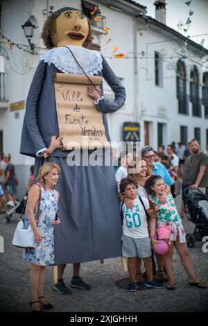 Famiglie che si godono il tradizionale festival dei giganti e delle bigheadi a Fuenteheridos, Huelva, Andalusia, Spagna. Scene natalizie di strada con grandi burattini e Foto Stock