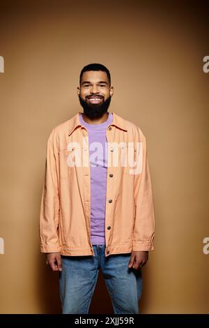 Uomo barbuto che si mette in posa su uno sfondo vivido. Foto Stock