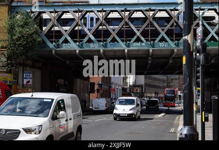 Londra - 06 10 2022: Veduta di Southwark Bridge Rd con ponte ferroviario e passaggio del treno Foto Stock