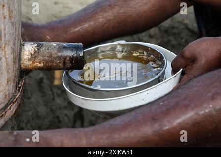 Apicoltori che lavorano in un allevamento di api vicino a un campo di masturba in un villaggio nel distretto di Barpeta, Assam, in India, mercoledì 22 dicembre 2021. Il Foto Stock