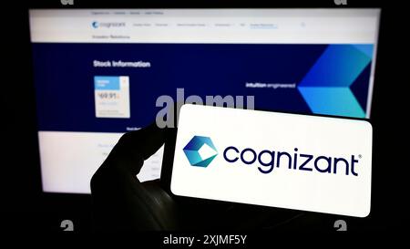 Stoccarda, Germania, 06-12-2022: Persona con smartphone con logo di Cognizant Technology Solutions Corporation sullo schermo davanti al sito Web. Foto Stock