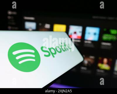 Stoccarda, Germania, 01-29-2023: Smartphone con logo della società di streaming musicale Spotify Technology S.A. sullo schermo di fronte al sito Web aziendale. Concentrati Foto Stock