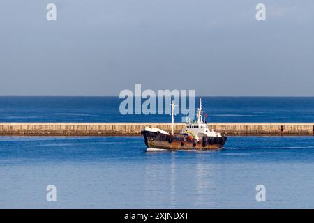 Una vecchia piccola nave ai limiti del porto maltese di Vittoriosa Foto Stock