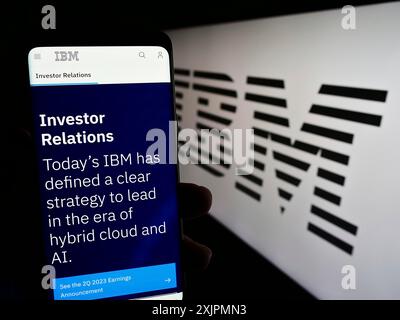 Stoccarda, Germania, 07-29-2023: Persona che tiene un cellulare con pagina web della International Business Machines Corporation (IBM) sullo schermo con logo. Foto Stock