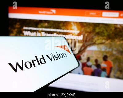 Stoccarda, Germania, 10-06-2023: Cellulare con logo dell'organizzazione benefica World Vision International davanti al sito web. Concentrati al centro-sinistra di Foto Stock