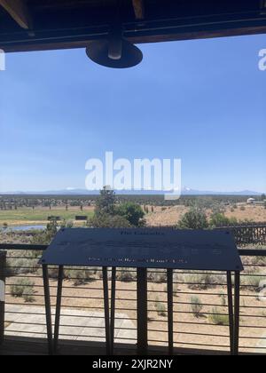 Vista su un ponte di legno in pietra verso le Cascades dal ponte di un ristorante del Brasada Ranch, un resort di lusso vicino a Bend, Oregon. Foto Stock