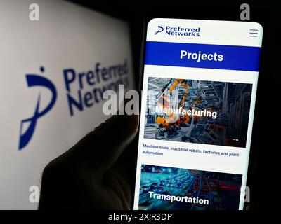 Stoccarda, Germania, 12-18-2023: Persona che detiene un cellulare con pagina web della società di intelligenza artificiale Preferred Networks Inc. Con logo. Concentrati su Foto Stock