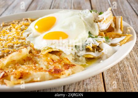 Vista ravvicinata di un piatto messicano per la colazione, con chilaquile e uova soleggiate. Foto Stock