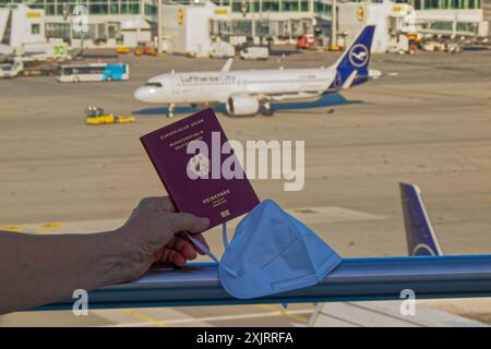 Die Corona-Fälle steigen an. MIT Reisepass und FFP2- Atemschutzmaske am Flughafen München. München Bayern Deutschland *** Corona casi in aumento con passaporto e respiratore FFP2 presso l'aeroporto di Monaco Monaco Baviera Germania Copyright: XRolfxPossx Foto Stock