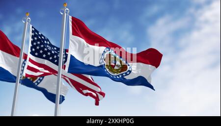 Bandiere dello stato del Missouri che sventolano con la bandiera nazionale americana in una giornata limpida. rendering dell'illustrazione 3d. Tessuto ondulato. Messa a fuoco selettiva Foto Stock