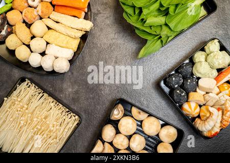 In un vassoio nero sono esposti diversi prodotti alimentari, tra cui funghi, asparagi e verdure verdi Foto Stock