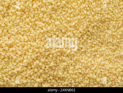 Giallo grezzo biologico sano couscous semi di grano fondo testurizzato. Foto Stock