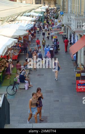 Parma, Italia 24 luglio 2024 folle di persone che camminano attraverso un mercato all'aperto in italia in una soleggiata giornata estiva Foto Stock