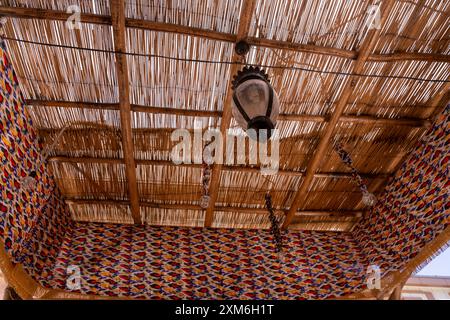 Una lampada pende dal soffitto di una stanza con un colorato Foto Stock