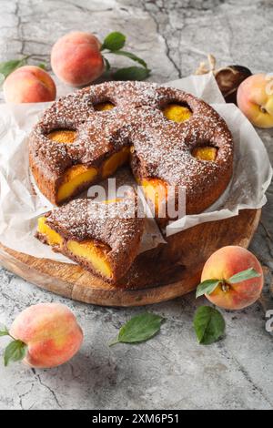 Deliziosa torta brownie al cioccolato alla pesca primo piano su una tavola di legno sul tavolo. Verticale Foto Stock