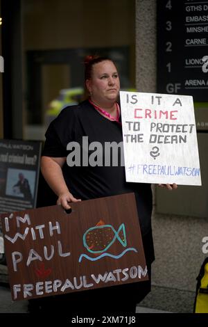 La gente partecipa a una protesta fuori dall'ambasciata danese a Dublino che chiede il rilascio del veterano attivista ambientalista e attivista anti-baleniera Paul Watson, che è stato arrestato a Nuuk, in Groenlandia, per un mandato di arresto internazionale emesso dal Giappone. Data foto: Venerdì 26 luglio 2024. Foto Stock