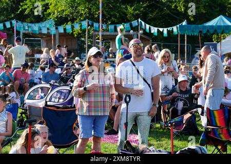 Lulworth, Dorset, Regno Unito. 26 luglio 2024. Uomo e donna in piedi tra la folla godendo di musica dal vivo al festival familiare Camp Bestival, 26 luglio 2024, credito: Dawn Fletcher-Park/Alamy Live News Foto Stock