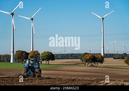 Agricoltore che lavora nei campi, con un trattore, un parco eolico sopra il villaggio di Lichtenau, autoproclamata città energetica, distretto di Paderborn, OWL, A North Foto Stock