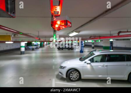 Parcheggi sotterranei, parcheggi multipiano, lampade rosse o verdi sul soffitto, mostrano ai conducenti se un posto auto è libero o occupato, e quindi Foto Stock